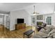 Living room featuring hardwood floors, a ceiling fan, and a fireplace at 1112 Newberry Dr, Mebane, NC 27302