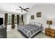 Spacious main bedroom featuring ceiling fan, neutral walls, and large windows at 1112 Newberry Dr, Mebane, NC 27302