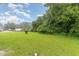 Spacious backyard featuring a lush lawn and mature trees, offering privacy and a serene outdoor space at 1209 Bobbitt Dr, Garner, NC 27529