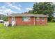 Charming brick home with a well-manicured lawn and mature trees at 1209 Bobbitt Dr, Garner, NC 27529