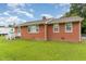 This brick house features an expansive lawn with mature shade trees at 1209 Bobbitt Dr, Garner, NC 27529