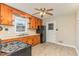 Kitchen featuring wooden cabinets, black appliances, ceiling fan, and tile flooring at 1209 Bobbitt Dr, Garner, NC 27529