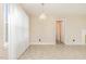 Bright, open-concept living space with chandelier and view to doorway at 1209 Bobbitt Dr, Garner, NC 27529