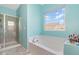 Bright bathroom featuring a large soaking tub, a separate shower, and a window at 1217 Trilogy Blvd # 174, Morrisville, NC 27560