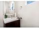 Half bathroom featuring pedestal sink, beveled mirror, and a neutral color scheme at 1217 Trilogy Blvd # 174, Morrisville, NC 27560