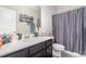 Modern bathroom with a dark vanity, quartz countertops, and a decorative shower curtain at 1217 Trilogy Blvd # 174, Morrisville, NC 27560