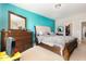 Primary bedroom featuring a tufted headboard, matching dresser, and walk-in closet at 1217 Trilogy Blvd # 174, Morrisville, NC 27560