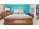 Primary bedroom with a tufted headboard, wood floors and lots of natural light at 1217 Trilogy Blvd # 174, Morrisville, NC 27560