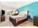 Primary bedroom with a tufted headboard, matching dresser, and lots of natural light at 1217 Trilogy Blvd # 174, Morrisville, NC 27560