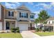 Charming townhome featuring an attached garage, a well maintained lawn and delightful front yard landscaping at 1217 Trilogy Blvd # 174, Morrisville, NC 27560