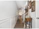 Inviting hallway with wood floors, wainscoting, and stairway access to upper levels at 1217 Trilogy Blvd # 174, Morrisville, NC 27560