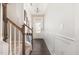 Inviting hallway with wood floors, wainscoting, and stairway access to upper levels at 1217 Trilogy Blvd # 174, Morrisville, NC 27560