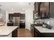 Spacious kitchen showcasing dark cabinetry, stainless steel appliances, and granite countertops at 1217 Trilogy Blvd # 174, Morrisville, NC 27560