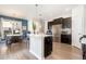 Modern kitchen featuring gray wood-style flooring, large island, and stainless steel appliances at 1217 Trilogy Blvd # 174, Morrisville, NC 27560