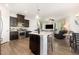 Bright open floorplan featuring kitchen with dark cabinetry and stainless steel appliances at 1217 Trilogy Blvd # 174, Morrisville, NC 27560