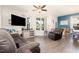 Spacious living room features a ceiling fan, a flat screen television and an attached dining area at 1217 Trilogy Blvd # 174, Morrisville, NC 27560