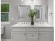 Bright bathroom with double sinks, white cabinets and framed mirrors at 123 Becket Bend Bnd, Pittsboro, NC 27312