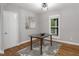 Bright dining area featuring hardwood floors, stylish rug, modern light fixture, and glass top table near window at 123 Becket Bend Bnd, Pittsboro, NC 27312