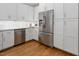 Bright kitchen boasts stainless steel refrigerator, marble backsplash, and white cabinetry at 123 Becket Bend Bnd, Pittsboro, NC 27312
