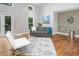Stylish living room with gray sofa, hardwood floors, modern decor, and ample natural light at 123 Becket Bend Bnd, Pittsboro, NC 27312