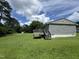 Home's exterior with a wooden deck and spacious backyard at 124 Kearney Ave, Oxford, NC 27565