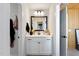 Stylish bathroom featuring white vanity with black hardware and flowers in a modern neutral colored home at 1305 Westerland Way # 17, Durham, NC 27703