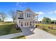 Charming two-story home featuring a covered porch and gray siding, complemented by a well-manicured lawn at 1305 Westerland Way # 17, Durham, NC 27703