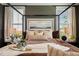 Inviting bedroom showcases a four-poster bed and soft, natural lighting from the nearby windows at 1305 Westerland Way # 17, Durham, NC 27703