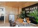 Modern office with wood paneled walls and black accent wall featuring Podcast On Air sign and sleek, contemporary furniture at 1305 Westerland Way # 17, Durham, NC 27703