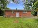 View of the home's exterior and backyard, showing the brick and lawn at 1311 Meadow Ln, Chapel Hill, NC 27516
