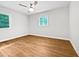 A bright bedroom features hardwood floors and natural light coming in from the windows at 1311 Meadow Ln, Chapel Hill, NC 27516