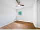 The bedroom has hardwood floors, a ceiling fan, and a large window to let in light at 1311 Meadow Ln, Chapel Hill, NC 27516