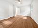 Bright bedroom featuring hardwood floors, a ceiling fan, and a double-door closet at 1311 Meadow Ln, Chapel Hill, NC 27516