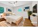 Bright bedroom featuring a ceiling fan, wood floors, and natural light from the windows at 1311 Meadow Ln, Chapel Hill, NC 27516