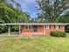 Charming one-story brick home with a covered carport and a well-maintained front yard at 1311 Meadow Ln, Chapel Hill, NC 27516