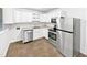 The kitchen has stainless steel appliances, white cabinets, and a stainless steel sink at 1311 Meadow Ln, Chapel Hill, NC 27516