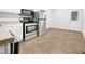 The kitchen has stainless steel appliances and white cabinets, and an open area for dining at 1311 Meadow Ln, Chapel Hill, NC 27516