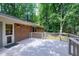 Spacious back deck with wood railings, perfect for outdoor entertaining in a lush backyard setting at 1416 Bramble Dr, Durham, NC 27712