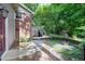 Landscaped backyard includes a wooden deck with stairs, fire pit and a cozy storage building at 1416 Bramble Dr, Durham, NC 27712