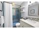 Bathroom featuring vanity with marble top, blue tile shower and blue tub, and a white shower curtain at 1416 Bramble Dr, Durham, NC 27712
