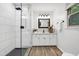 Modern bathroom featuring a walk-in shower with black fixtures, a vanity, and stylish tile flooring at 1416 Bramble Dr, Durham, NC 27712