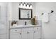 Bright bathroom vanity with white countertops, dark fixtures, and decorative accents at 1416 Bramble Dr, Durham, NC 27712