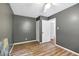 Gray bedroom featuring neutral floors, modern fan, white door and plenty of natural light at 1416 Bramble Dr, Durham, NC 27712