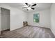 Bright bedroom featuring neutral carpet and paint, a ceiling fan and a window with leafy view at 1416 Bramble Dr, Durham, NC 27712