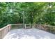 Spacious wooden deck is surrounded by lush trees, offering privacy and a great outdoor living space at 1416 Bramble Dr, Durham, NC 27712
