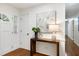 Bright entryway with hardwood floors, showcasing a console table and elegant floral artwork at 1416 Bramble Dr, Durham, NC 27712