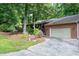 Ranch-style home with brick and siding, featuring a two-car garage and meticulously landscaped front yard at 1416 Bramble Dr, Durham, NC 27712