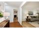 Bright foyer with hardwood floors leading into a cozy living room featuring a fireplace and comfortable seating at 1416 Bramble Dr, Durham, NC 27712