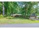 Charming brick ranch home surrounded by mature trees and lush landscaping, offering a serene and private setting at 1416 Bramble Dr, Durham, NC 27712