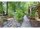 Landscaped front yard featuring a rock garden, lush shrubs, and a charming walkway leading to the entrance at 1416 Bramble Dr, Durham, NC 27712